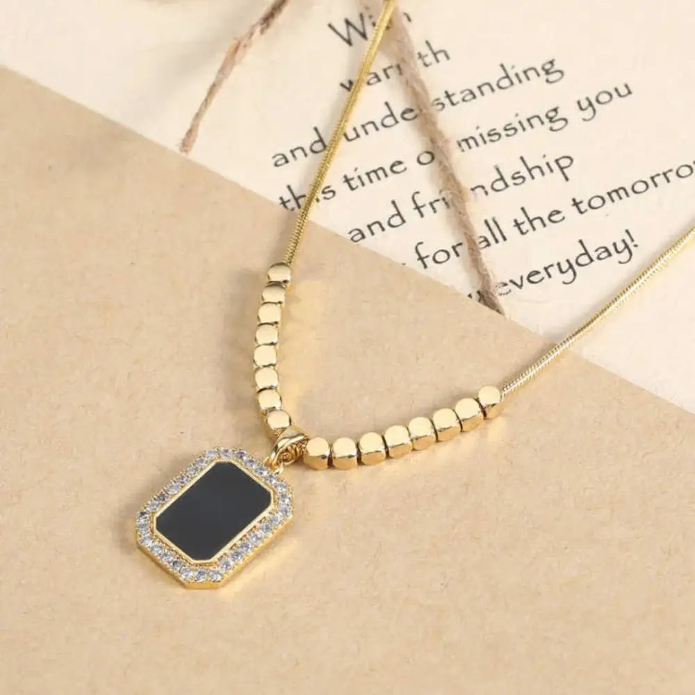 COLLIER NOIR AVEC PETIT CARRÉ LARIAT - MARYANA BIJOUX